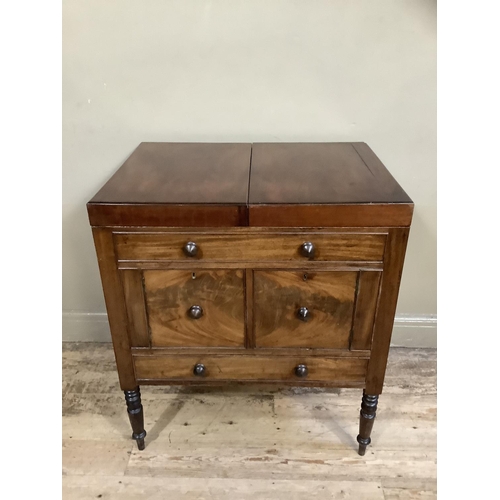 511 - An early twentieth century gentleman's washstand in mahogany, of Georgian design having twin fold ou... 