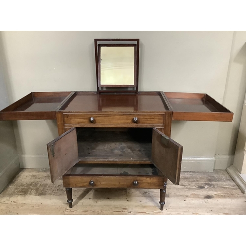 511 - An early twentieth century gentleman's washstand in mahogany, of Georgian design having twin fold ou... 