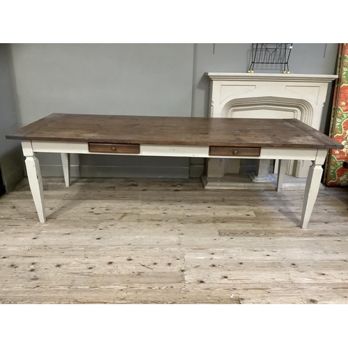 512 - A French farmhouse table having a fruitwood three plank surface with cleated ends and on four square... 