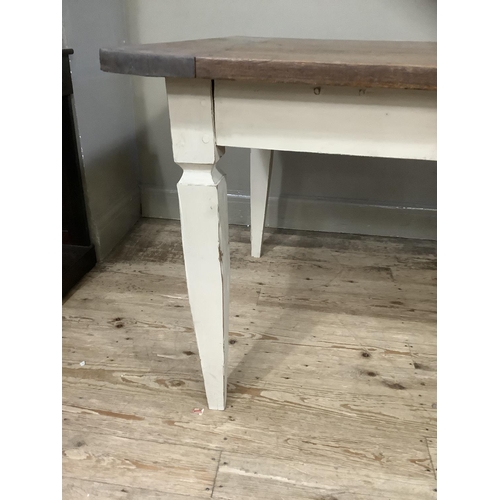 512 - A French farmhouse table having a fruitwood three plank surface with cleated ends and on four square... 