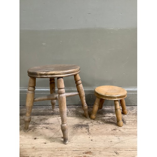 116 - A pine milking stool on four legs and another smaller