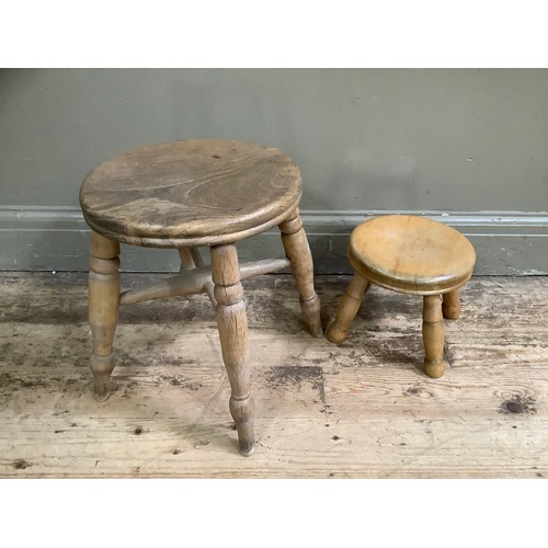 116 - A pine milking stool on four legs and another smaller