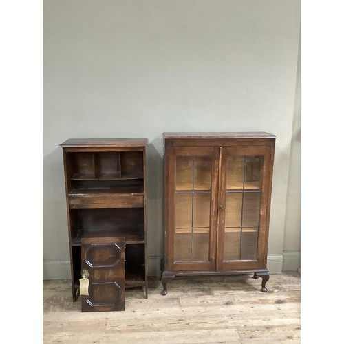 484 - A 1940's oak two door bookcase with leaded glazed doors on cabriole legs together with a fall front ... 