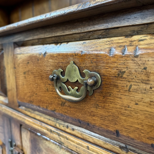 357 - An oak reproduction dresser and plate rack in the style of Titchmarsh and Goodwin, base having three... 