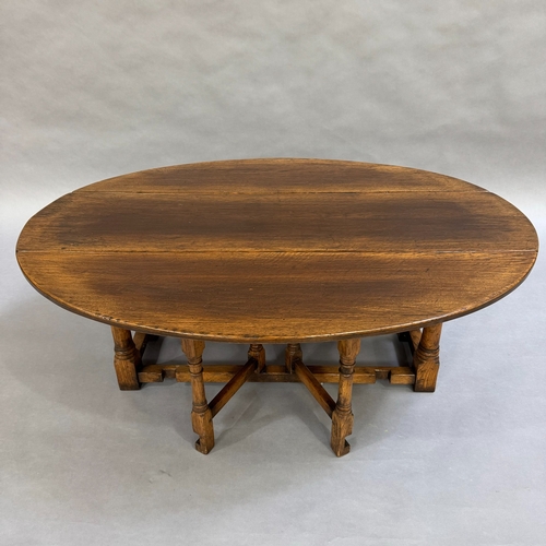 356 - An oak drop leaf coffee table in the style of Titchmarsh and Goodwin having gate legs, 120cm long, 9... 