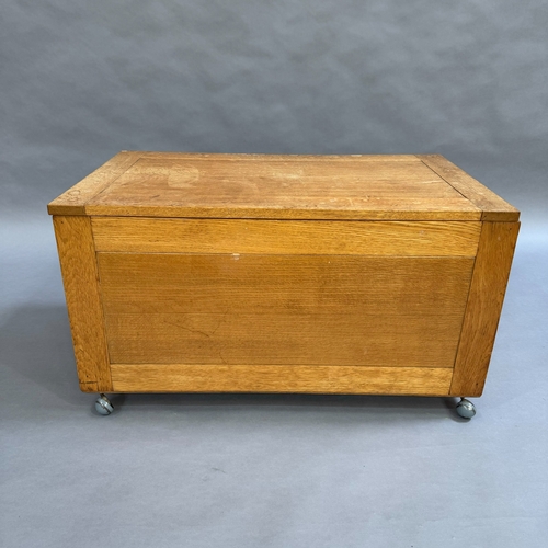 120 - An oak ottoman with lift up lid, on castors, 91cm wide, 50cm high, 54cm deep