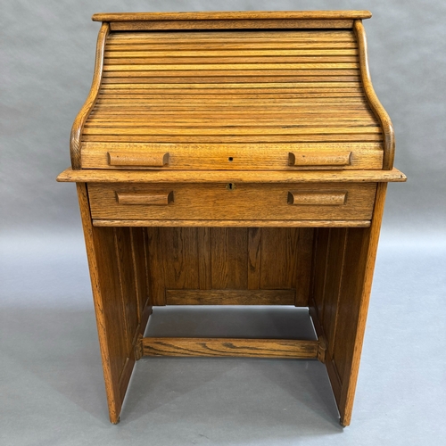 330 - An 1930/40s oak roll top desk having a roll top front, interior fitted with pigeon holes and documen... 