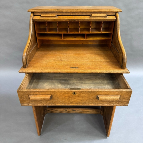 330 - An 1930/40s oak roll top desk having a roll top front, interior fitted with pigeon holes and documen... 