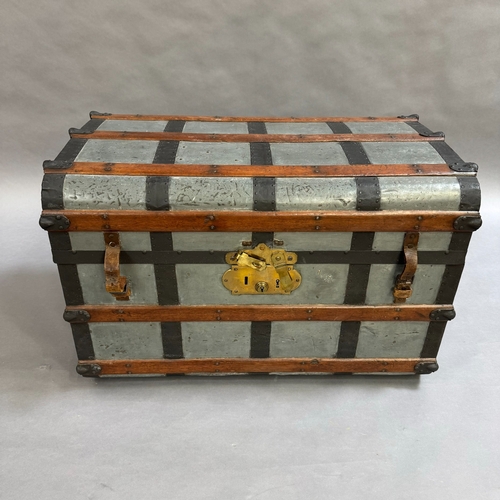 305 - A metal trunk bound with wooden supports, with fitted interior and leather carrying handles, 90cm wi... 