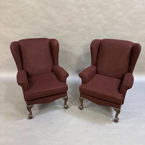 348 - A pair of 1960's wing back armchairs upholstered in aubergine fabric, cabriole claw and ball feet, s... 