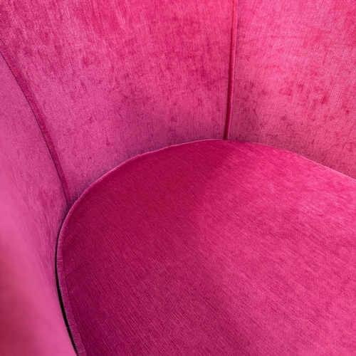 345 - A modern tub chair and foot stool upholstered in hot pink