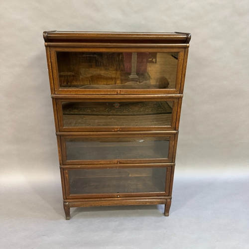 309 - An oak 1930's Globe Wernicke stacking bookcase, four height with glazed doors, 87cm wide, 142cm high... 