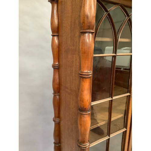 307 - A mahogany reproduction glazed bookcase above two door cupboard, single slide and single drawer, tur... 