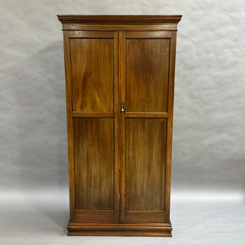 301 - An Edwardian mahogany bachelors wardrobe, two panelled doors revealing fitted interior with pull out... 