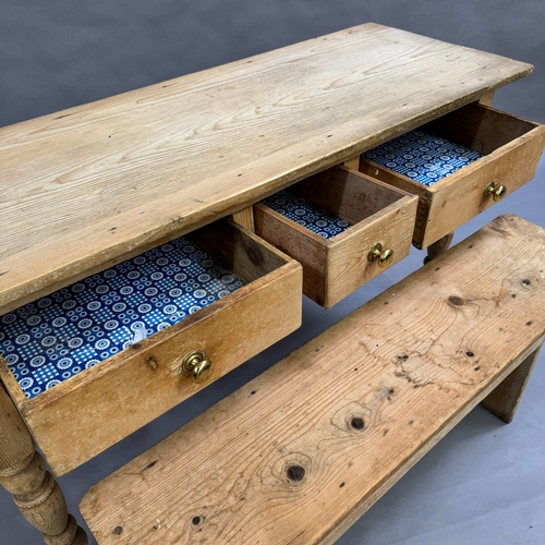 114 - A Victorian stripped pine kitchen side table, one short central drawers flanked by two longer drawer... 