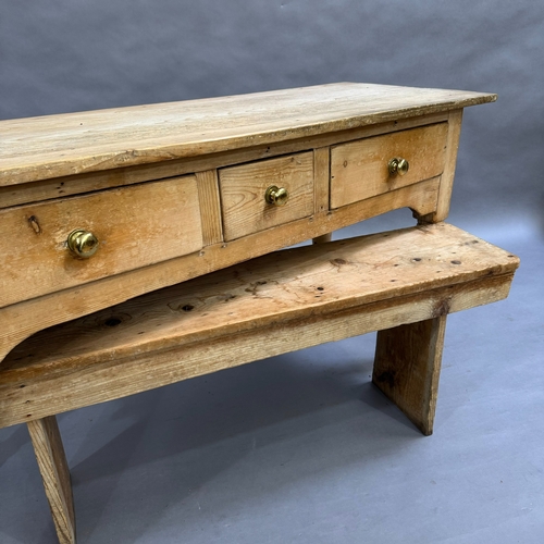 114 - A Victorian stripped pine kitchen side table, one short central drawers flanked by two longer drawer... 