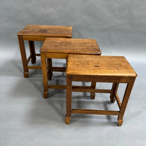 322 - A walnut stacking nest of three tables of deco design, largest 48cm x 32cm