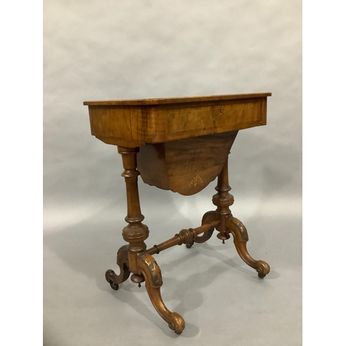 323 - A Victorian walnut sewing table on twin supports, cabriole carved legs, satinwood inlay with foliate... 