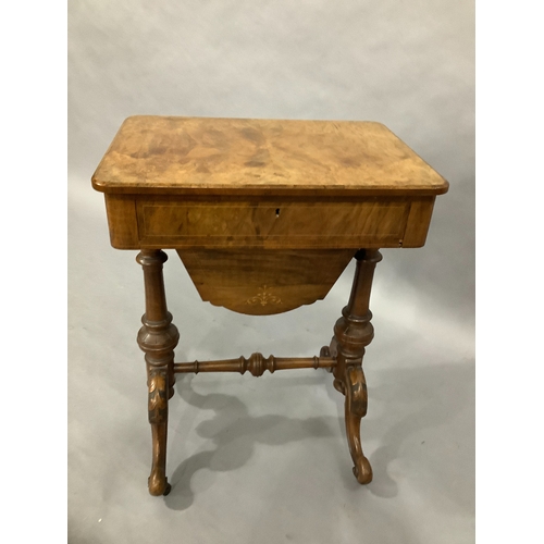 323 - A Victorian walnut sewing table on twin supports, cabriole carved legs, satinwood inlay with foliate... 