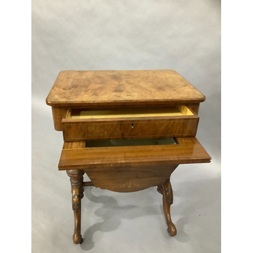 323 - A Victorian walnut sewing table on twin supports, cabriole carved legs, satinwood inlay with foliate... 