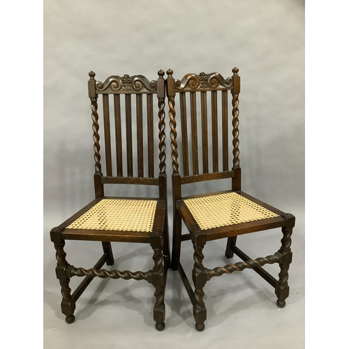 102 - A pair of oak high back dining chairs with barley twist supports and cane seating