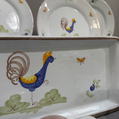 26 - A set of Poterie à La Chapelle des Pots tableware, painted with a cockerel and sprigged flowers, inc... 