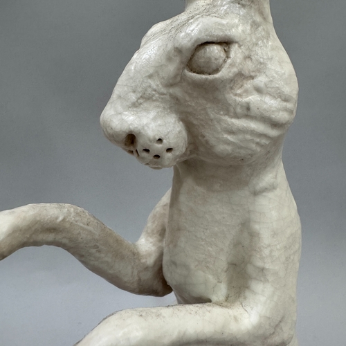 42 - A studio pottery sculpture of a hare by Alison Coaton, in off-white crackle glaze, artist's mark to ... 