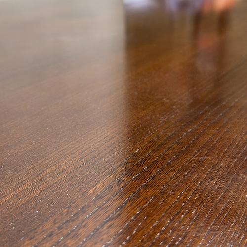 351 - A dark stained dining table on twin refectory supports, 153cm long, 91cm wide