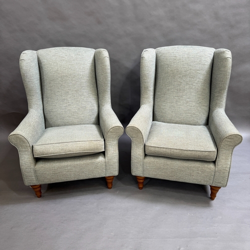 346 - A pair of modern wing back chairs upholstered in a light grey/green fabric