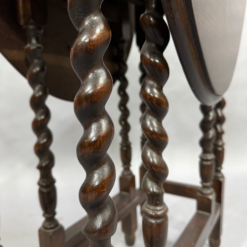 321 - A 1930's oak barley twist gate leg table, 60cm x 90cm when fully opened