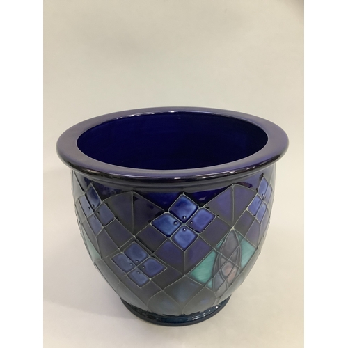 10 - A Moorcroft Violet pattern jardinière , tubelined and enamelled in shades of deep blue, green and ma... 