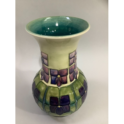 2 - A Moorcroft art pottery vase in Violet pattern, enamelled and tubelined in green and shades of mauve... 