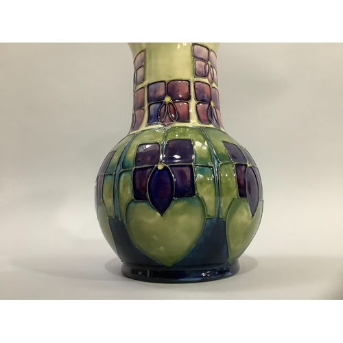 2 - A Moorcroft art pottery vase in Violet pattern, enamelled and tubelined in green and shades of mauve... 