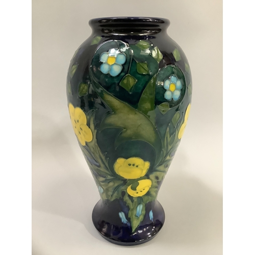 4 - A Moorcroft Buttercup pattern vase, tube lined and enamelled in shades of blue, green and yellow, ba... 