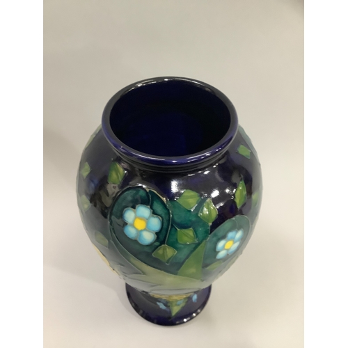 4 - A Moorcroft Buttercup pattern vase, tube lined and enamelled in shades of blue, green and yellow, ba... 