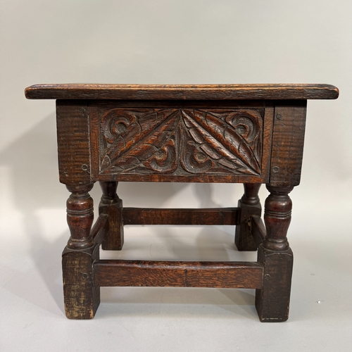 359 - An early 20th century oak slipper/fireside box, carved to the frieze with leafage, on turned and squ... 