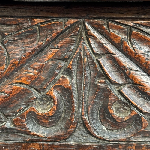 359 - An early 20th century oak slipper/fireside box, carved to the frieze with leafage, on turned and squ... 