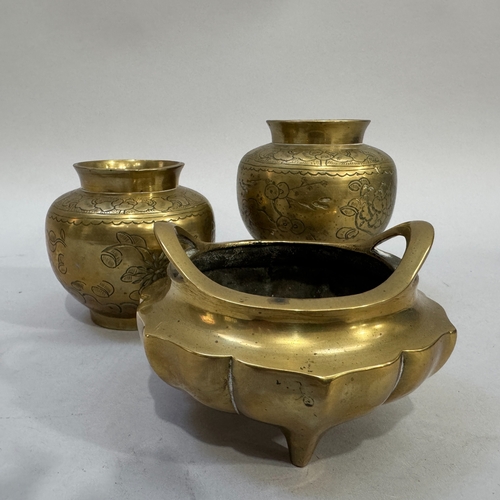 58 - A 19th century Chinese brass two-handled koro of compressed globe form, on three feet, 11.5cm diamet... 