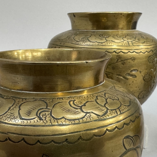 58 - A 19th century Chinese brass two-handled koro of compressed globe form, on three feet, 11.5cm diamet... 