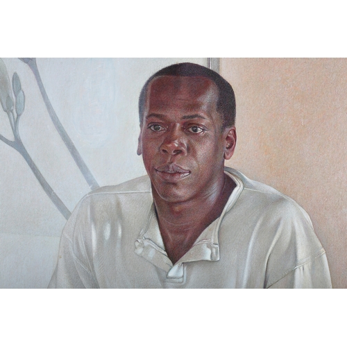 13 - Wade Reynolds (American 1929-2001), portrait of a young black man, wearing a white sweatshirt with A... 