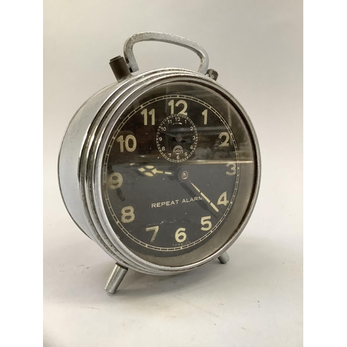 75 - A vintage chrome cased repeat alarm clock by Haller having luminous Arabic numerals on black dial, 1... 