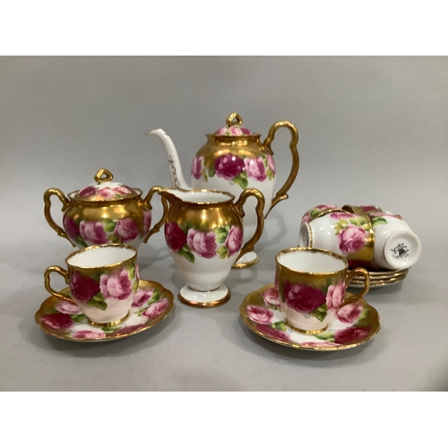 72 - A Royal Albert china tea service printed with roses in shades of pink, highlighted in gilt on a whit... 