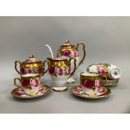 72 - A Royal Albert china tea service printed with roses in shades of pink, highlighted in gilt on a whit... 