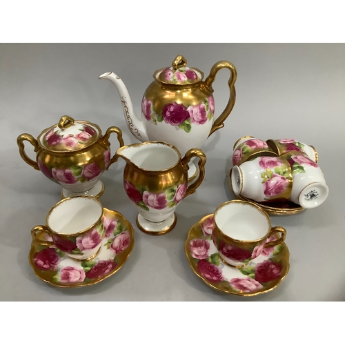 72 - A Royal Albert china tea service printed with roses in shades of pink, highlighted in gilt on a whit... 