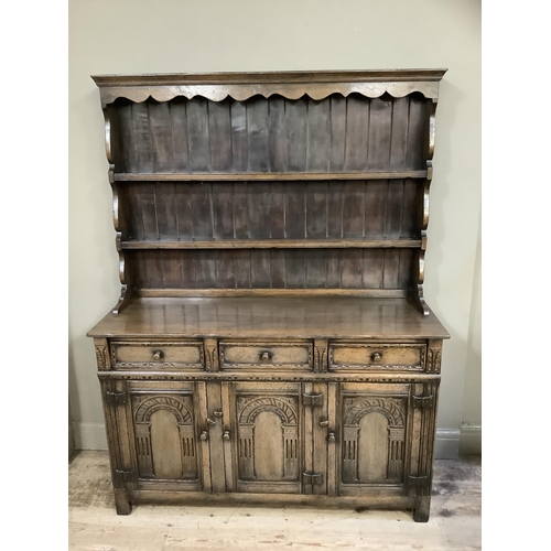 361 - A Titchmarsh & Goodwin oak dresser and rack, having a moulded and ogee shaped cornice above a planke... 