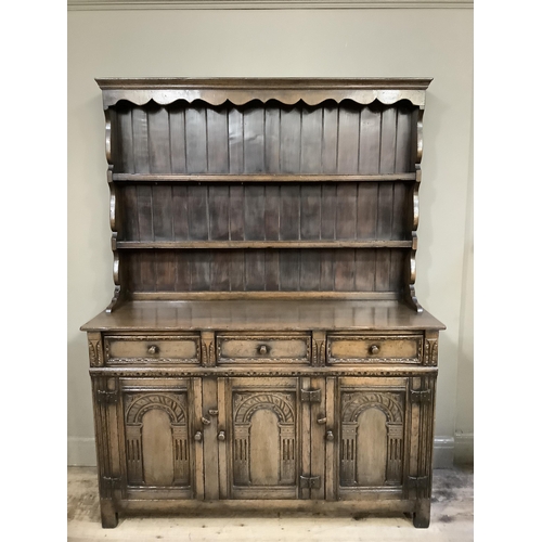 361 - A Titchmarsh & Goodwin oak dresser and rack, having a moulded and ogee shaped cornice above a planke... 