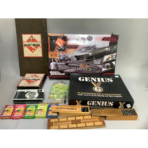 92 - A box of games including dominoes, cribbage, card games, Picture This, Monopoly, Genius, Fast and Fu... 