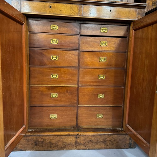 316 - A pair of walnut two door bookcases, two doors below with revealing filing drawers, the sides having... 