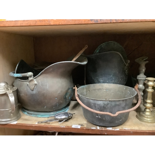 100 - A large collection of brass and copper items to include jam pans, trivets, coal helmets, candlestick... 