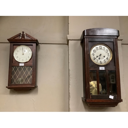 115 - A 1940s wall clock together with a further reproduction wall clock